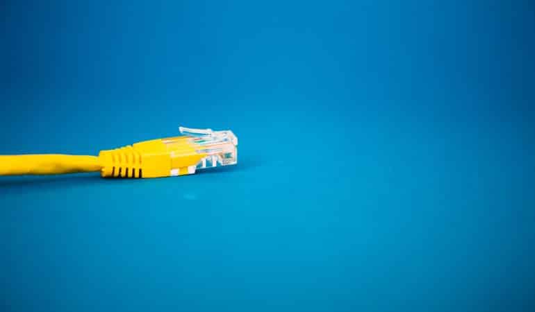 a yellow ethernet cable on a blue background
